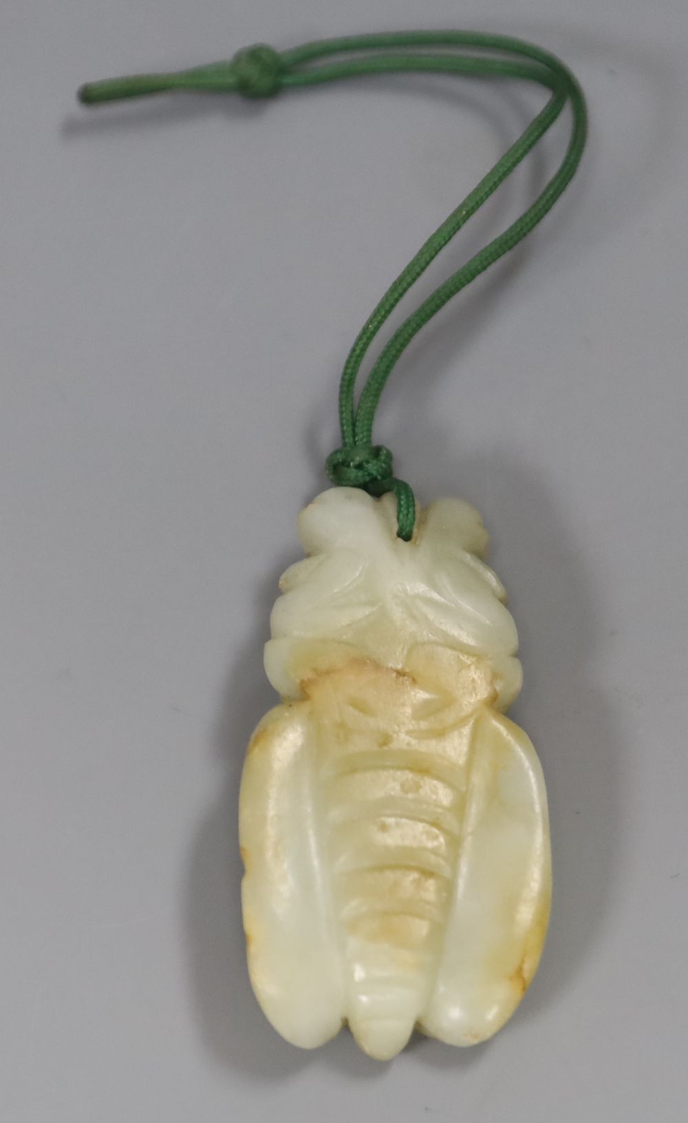 A Chinese carved jade cicada pendant, 5.5cm